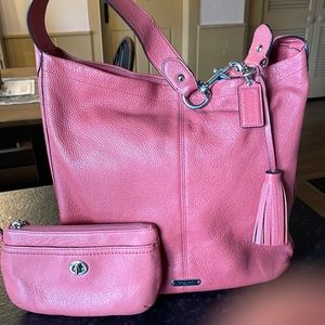 Burnt orange colored coach shoulder bag with matching wristlet. Sold as a set.